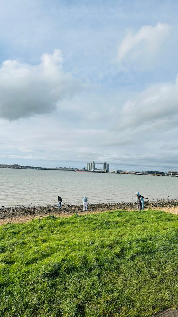 Family searching the shingle for shells at Weston Shore.