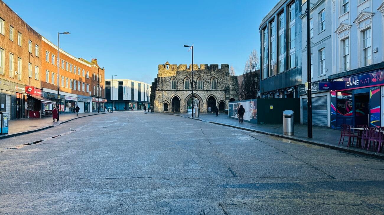 The Bargate landmark in Southampton framed by modern buildings and shops